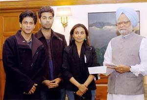 Prime Minister Manmohan Singh accepting donation from the Bollywood stars and directors. (PTI)